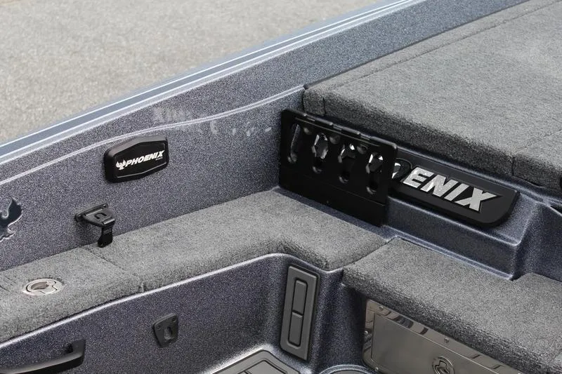 Slide: The Image of Interior of 2027 Phoenix 921 Elite X boat with gray carpet and storage compartments. - 15
