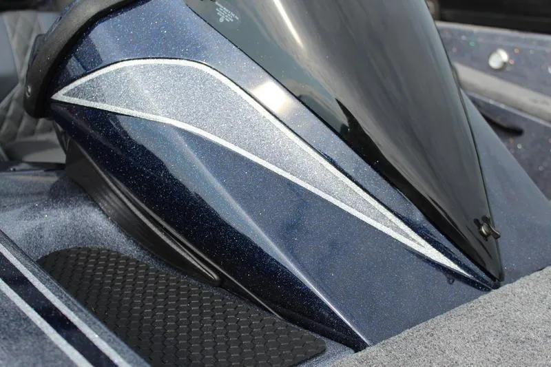 Slide: The Image of Close-up of a 2027 Phoenix 921 Elite X boat's sleek, metallic blue design. - 10