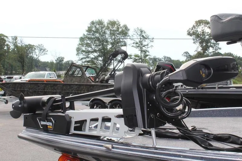 Slide: The Image of 2027 Phoenix 921 Elite X boat with Minn Kota trolling motor in a parking lot. - 17