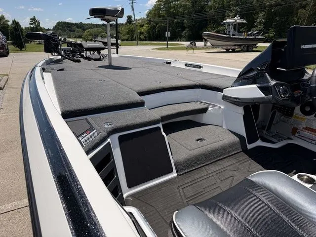 Slide: The Image of The image shows the deck of a 2024 Skeeter FXR21 Limited boat with gray upholstery. - 16