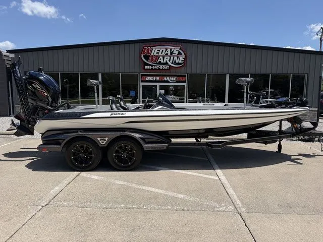 The Image of A 2024 Skeeter FXR21 Limited boat on a trailer in front of a building. - 1