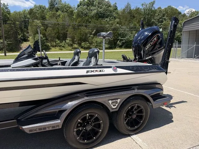 Slide: The Image of A 2024 Skeeter FXR21 Limited boat on a trailer, featuring a powerful outboard motor. - 15