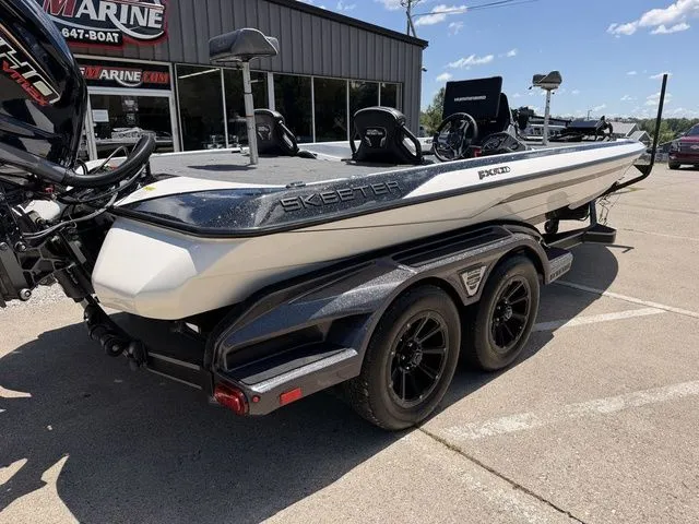 Slide: The Image of A 2024 Skeeter FXR21 Limited on a trailer in front of a building. - 4