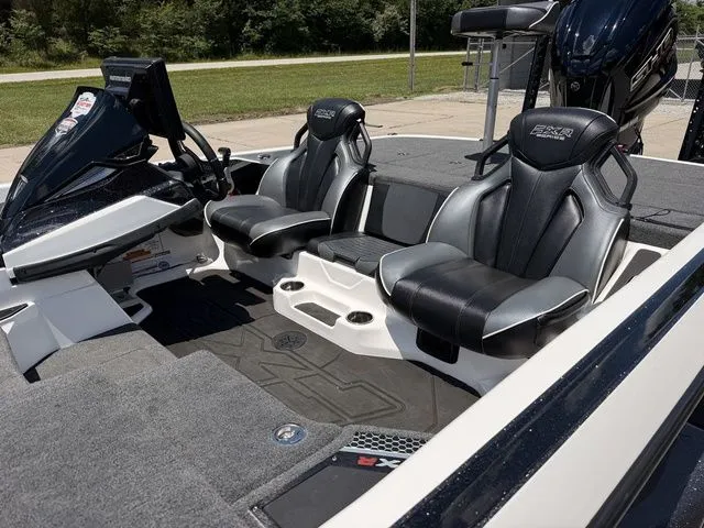 Slide: The Image of The image shows the cockpit of a 2024 Skeeter FXR21 Limited boat with two black seats. - 14