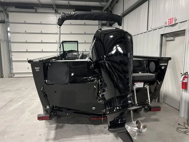 Slide: The Image of Rear view of a Lund 2075 Fisherman boat in a storage facility. - 4