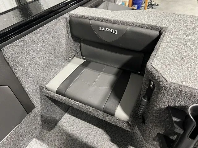 Slide: The Image of A cushioned seat with Lund logo inside a boat. - 8