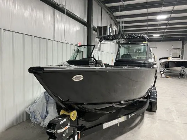 Slide: The Image of A black boat on a trailer inside a warehouse. - 3