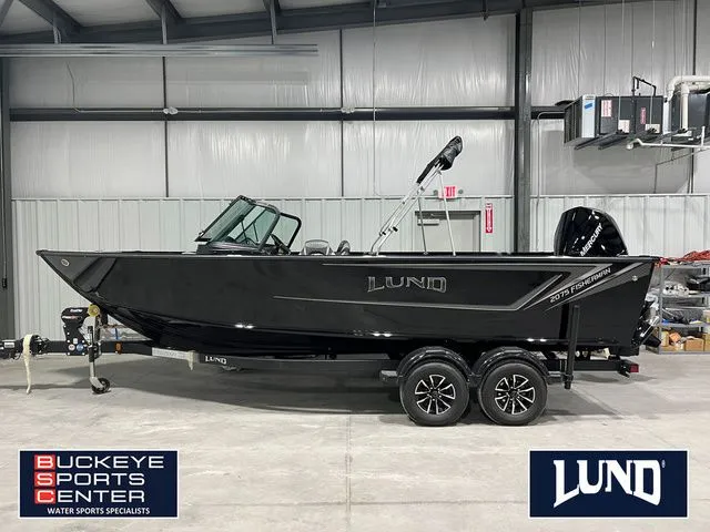 The Image of A black Lund 2075 Fisherman boat on a trailer inside a warehouse. - 1