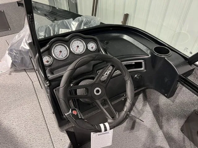 Slide: The Image of Dashboard of a Lund 2075 Fisherman with steering wheel and gauges. - 5
