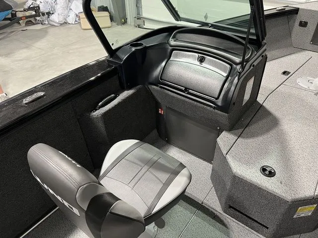 Slide: The Image of Interior of a 2027 Lund 2075 Fisherman with a gray seat and storage area. - 21