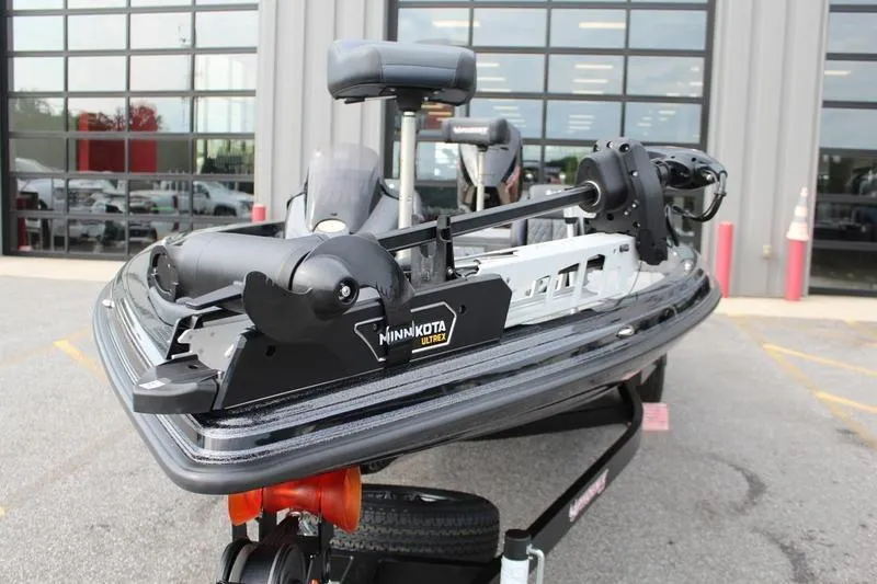 Slide: The Image of 2027 Phoenix 818 Pro boat with Minn Kota Ultrex motor, parked outside a building. - 11