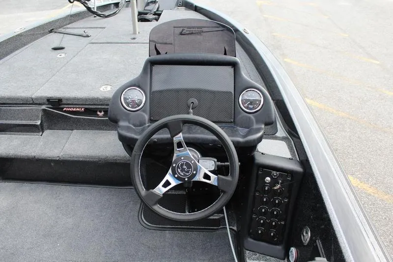 Slide: The Image of 2027 Phoenix 818 Pro boat dashboard with steering wheel and control panel. - 20