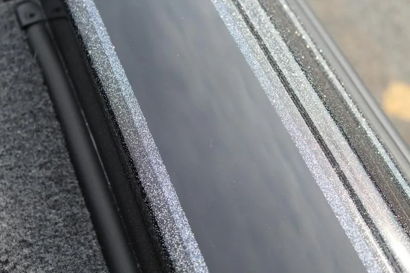 Slide: The Image of Close-up of 2027 Phoenix 818 Pro's sleek, reflective surface with textured edges. - 14