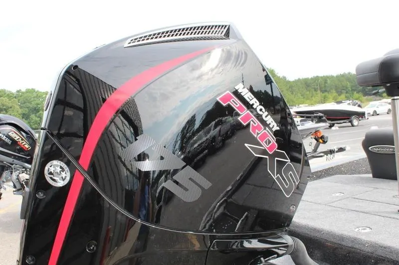 Slide: The Image of 2027 Phoenix 818 Pro boat with Mercury Pro XS engine, parked outdoors. - 24