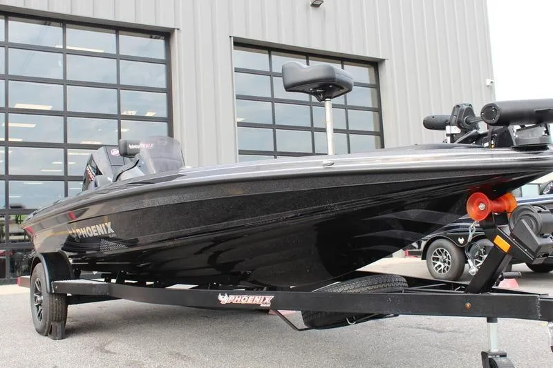 Slide: The Image of 2027 Phoenix 818 Pro boat on trailer outside a garage. - 7