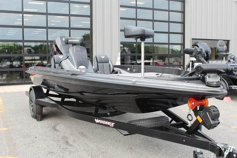 Slide: The Image of 2027 Phoenix 818 Pro fishing boat on trailer, parked outside a showroom. - 6