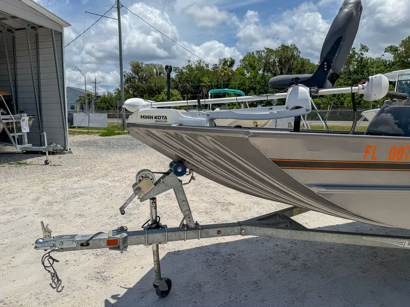 Slide: The Image of A 2022 Lowe Legacy boat on a trailer, featuring a Minn Kota motor at the front. - 7