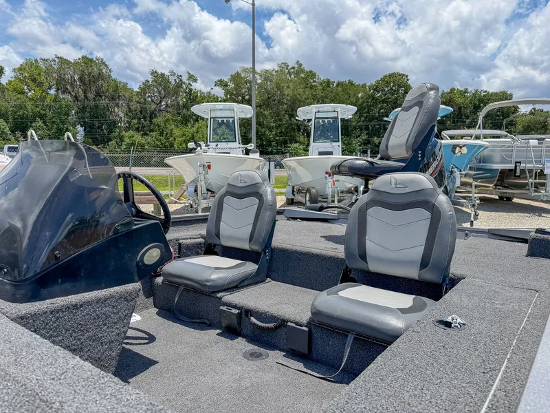 Slide: The Image of The image shows a 2022 Lowe Legacy boat with gray seats and a helm station. - 9