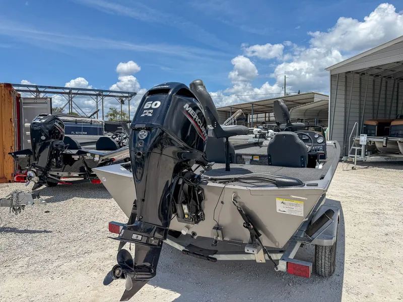 The Image of A 2022 Lowe Legacy boat with a Mercury 50 HP outboard motor on a trailer. - 1
