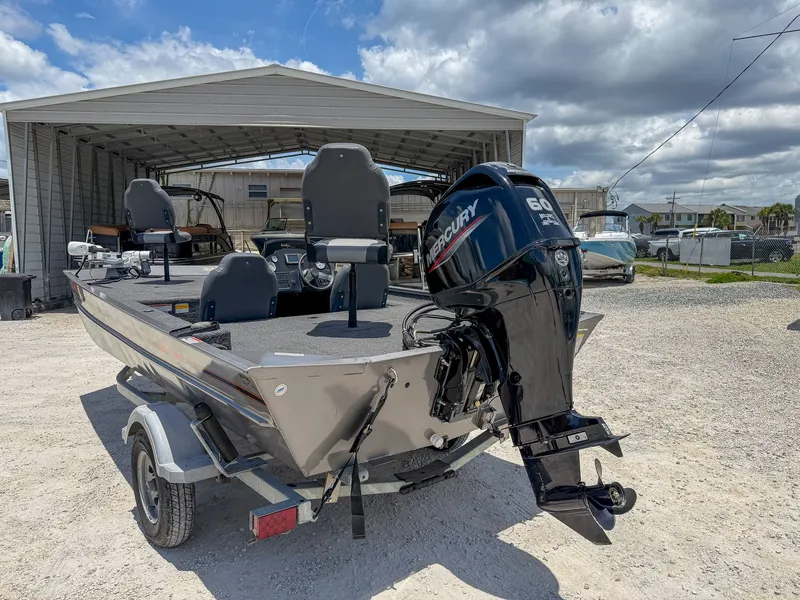 The Image of A 2022 Lowe Legacy boat on a trailer, featuring a Mercury outboard motor. - 1