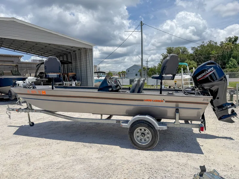 Slide: The Image of A 2022 Lowe Legacy boat on a trailer in an outdoor area. - 4