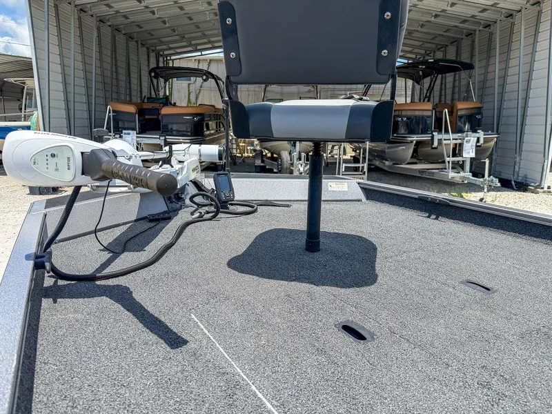 Slide: The Image of The image shows the deck of a 2022 Lowe Legacy boat with a seat and controls. - 6