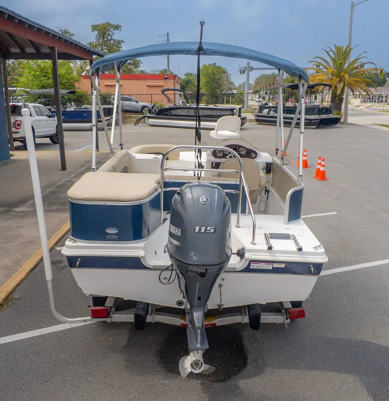 Slide: The Image of 2015 Hurricane FD 198 with Yamaha 115 outboard motor, parked in a lot. - 3