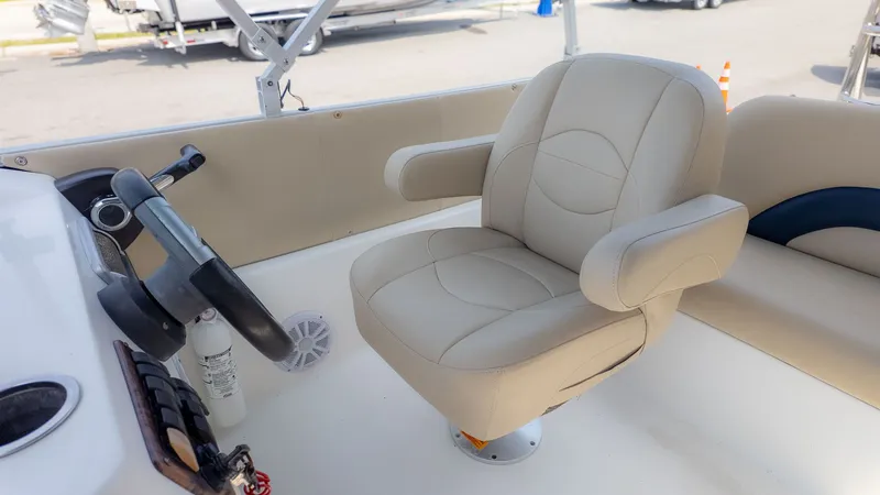 Slide: The Image of The image shows the helm of a 2015 Hurricane FD 198 boat with a beige captain's chair. - 18