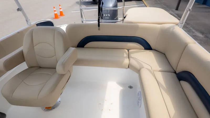 Slide: The Image of Interior view of a 2015 Hurricane FD 198 boat with beige upholstery and a swivel seat. - 4