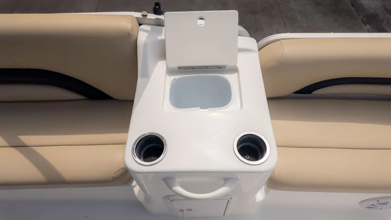 Slide: The Image of The image shows part of the interior of a 2015 Hurricane FD 198 boat with beige upholstery and cup holders. - 7