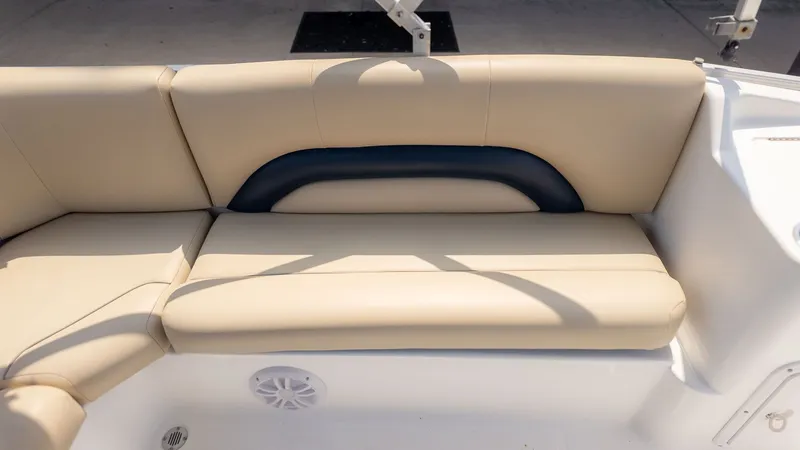 Slide: The Image of Beige seating on a boat with a blue backrest and speaker below. - 4