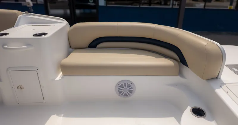 Slide: The Image of The image shows a beige seating area on a boat with cup holders and a speaker. - 9