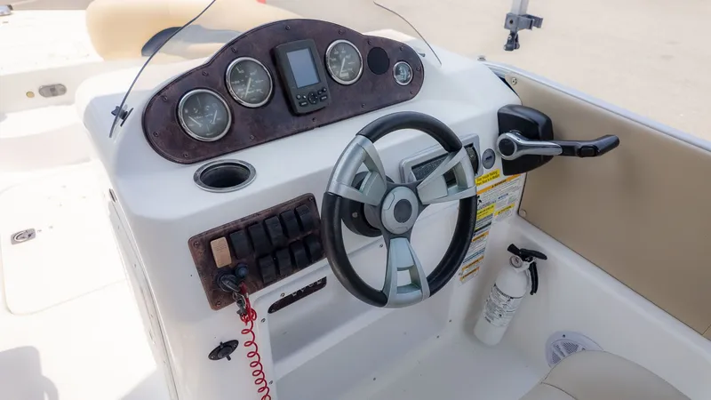 Slide: The Image of The image shows the helm of a 2015 Hurricane FD 198 boat with steering wheel and instruments. - 17
