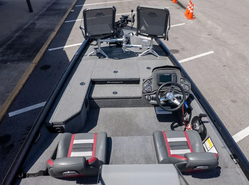 Slide: The Image of The image shows the cockpit of a Ranger RT178 boat with gray seats and a helm station. - 3