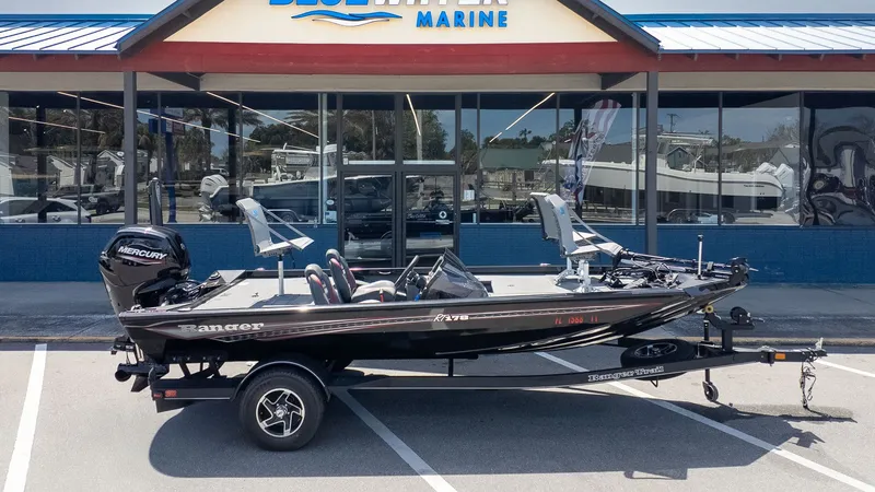 Slide: The Image of A 2023 Ranger RT178 boat on a trailer in front of a marine store. - 19