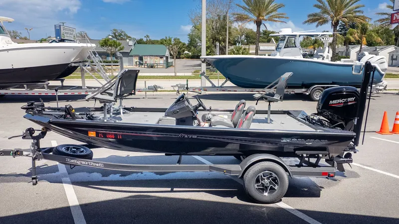 The Image of A black Ranger RT178 boat on a trailer in a parking lot, surrounded by other boats. - 1
