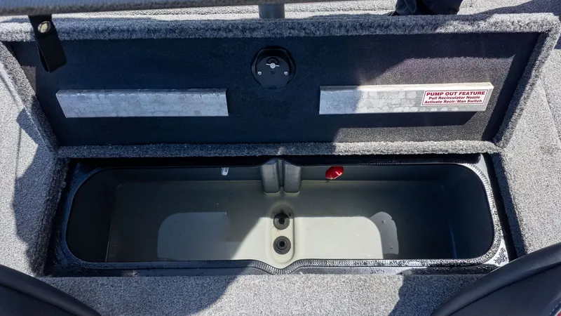 Slide: The Image of The image shows an open storage compartment on a boat with gray carpeting. - 7