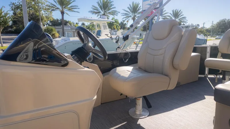 Slide: The Image of The image shows the cockpit of a 2022 Godfrey Sweetwater 2086 F with a beige seat. - 23
