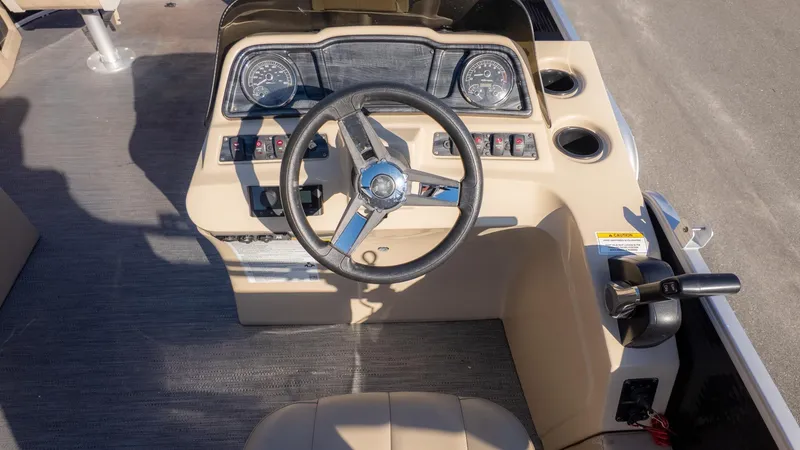 Slide: The Image of Helm of a 2022 Godfrey Sweetwater 2086 F with steering wheel and gauges. - 23