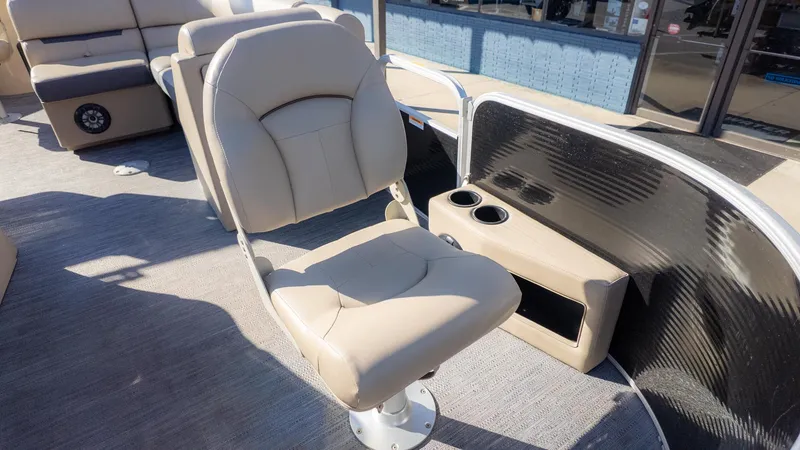Slide: The Image of A beige boat seat on a pontoon boat with cup holders and storage beside it. - 16