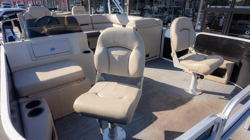 Slide: The Image of The image shows the interior of a Godfrey Sweetwater 2086 F pontoon boat with beige seating. - 17