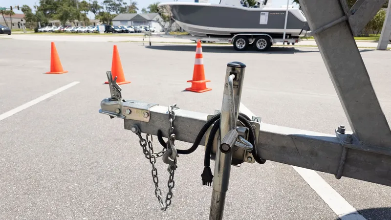Slide: The Image of A Carolina Skiff 17 LS boat on a trailer, surrounded by traffic cones in a parking lot. - 4