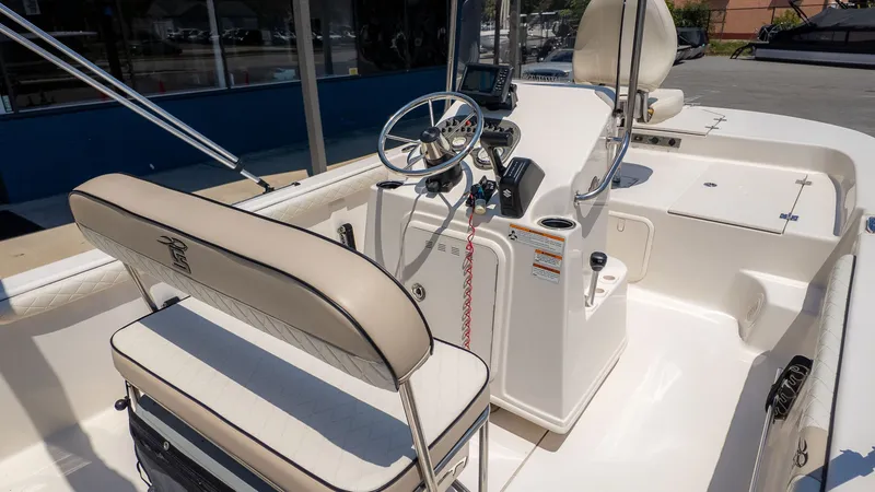 Slide: The Image of The image shows the cockpit of a 2023 Carolina Skiff 17 LS with a helm and seating. - 6