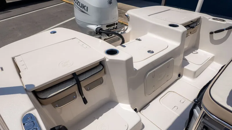 Slide: The Image of The image shows the deck of a Carolina Skiff 17 LS boat with storage and a Suzuki engine. - 9