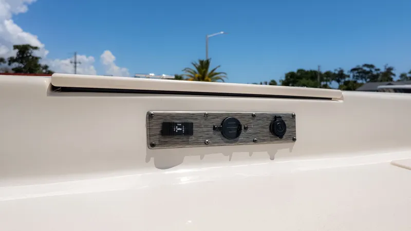 Slide: The Image of Close-up of a control panel on a boat, featuring switches and sockets. - 16