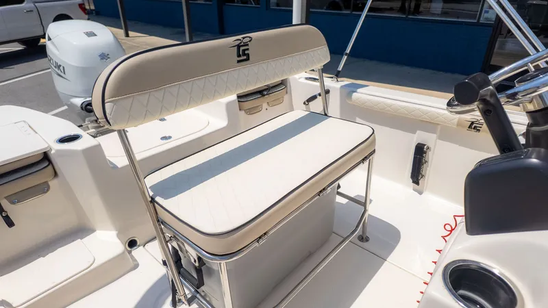 Slide: The Image of The image shows the seating area of a 2023 Carolina Skiff 17 LS boat with beige upholstery. - 12