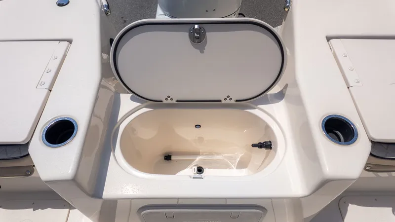 Slide: The Image of An open storage compartment on a Carolina Skiff 17 LS boat, surrounded by cup holders. - 8