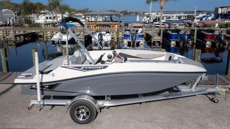 Slide: The Image of Starcraft J7 JET Standard 2027 on a trailer at the marina. - 18