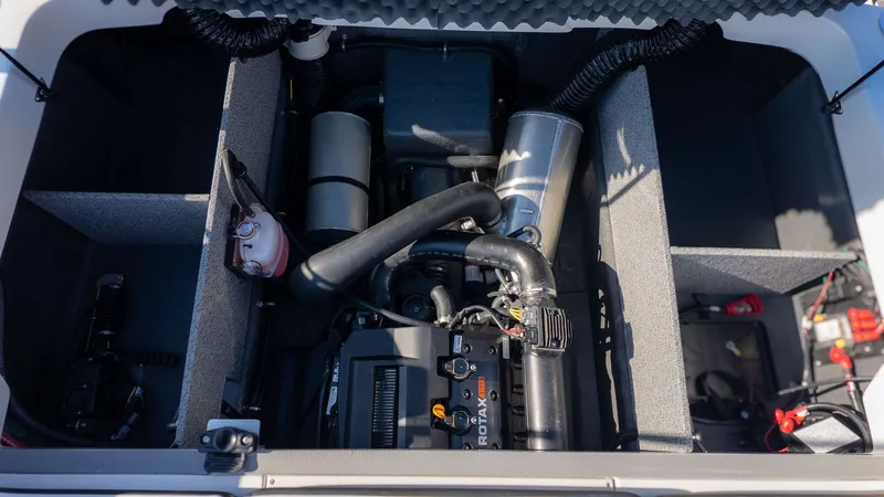 Slide: The Image of Engine compartment of a Starcraft J7 JET Standard boat, showing the engine and various components. - 6