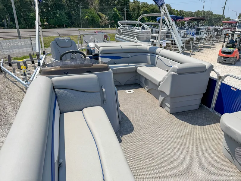 Slide: The Image of The image shows the interior of a Bennington 20 SVL pontoon boat with gray seating. - 8
